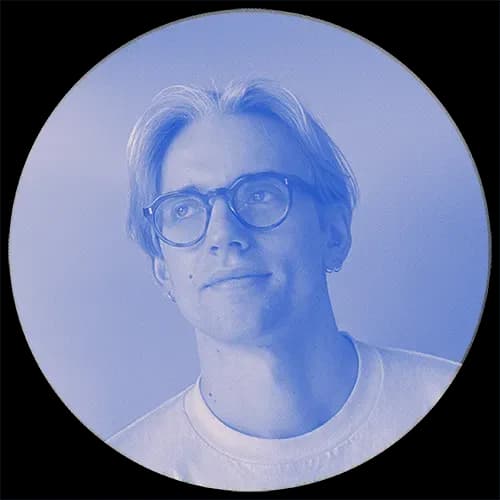Henry Richardson, blue tinted portrait with round glasses and swept-back hair in a white T-shirt