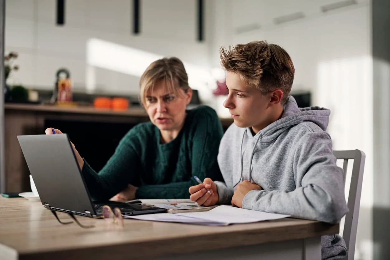 Parent helping their child study at home